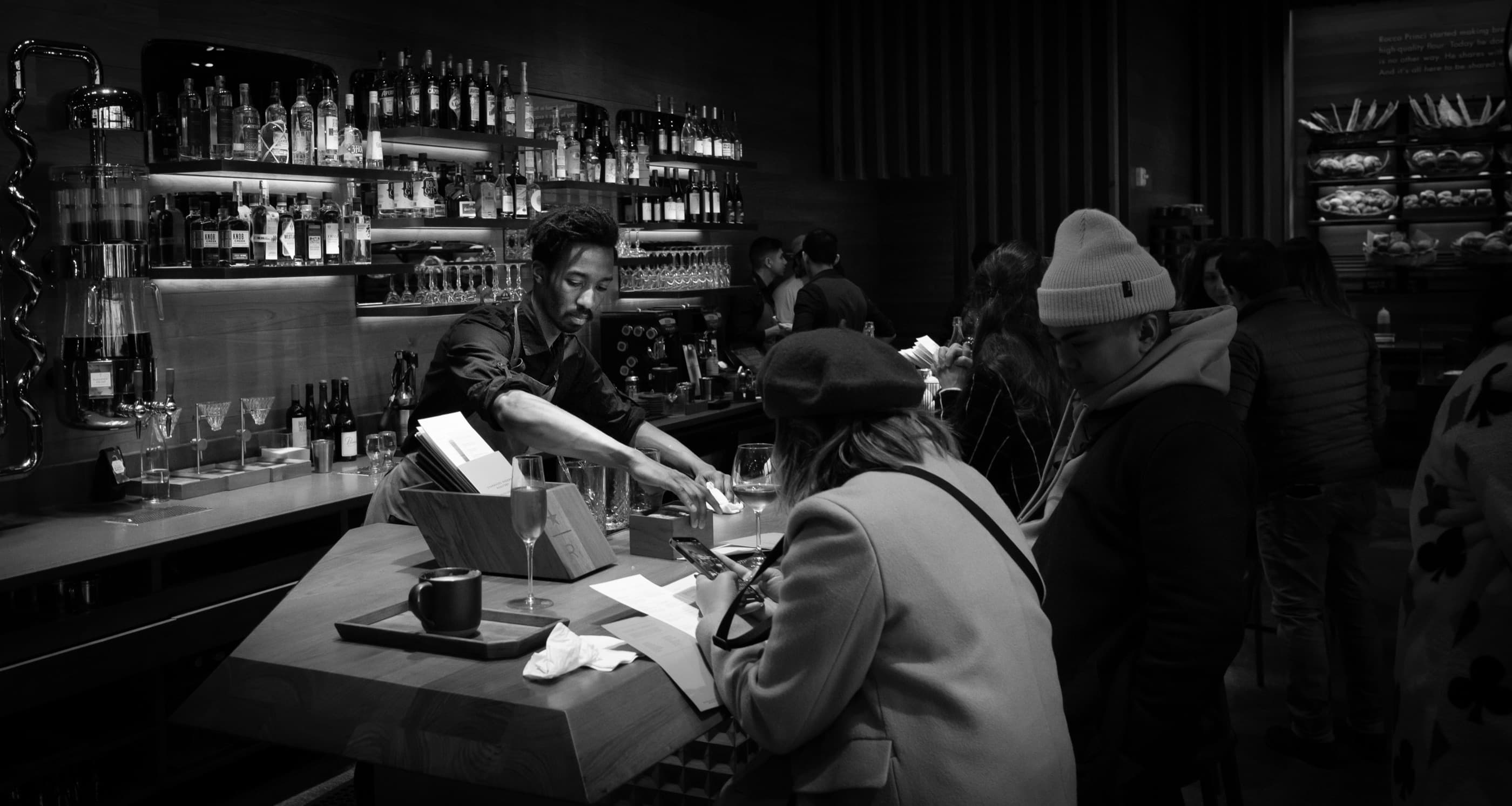 A bartender with his hands full during a busy night